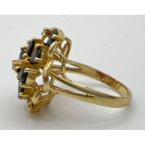 77 - A 14k gold large open design mount dress ring set with sapphires and diamonds. 8 teardrop cut midnig... 