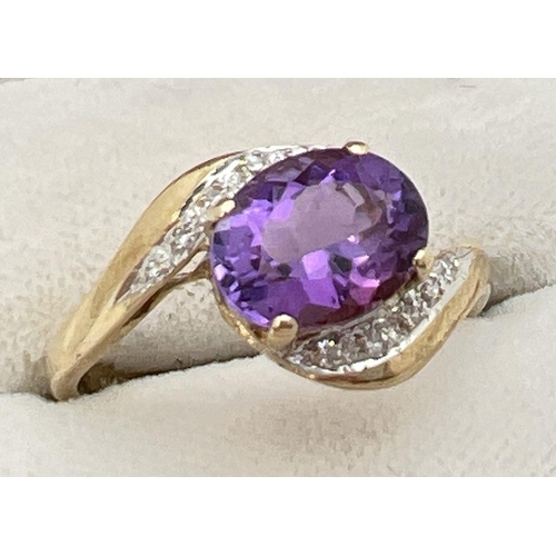 79 - A 9ct gold amethyst and diamond ring with twist design mount. A central oval cut amethyst with 5 sma... 