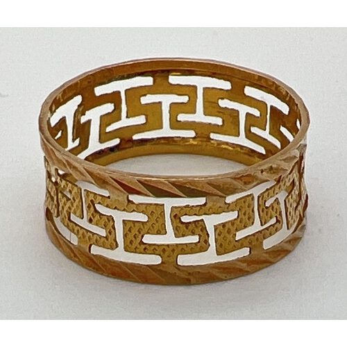 86 - A 14k gold band/wedding ring with pierced work Greek key design. 7mm band width. Marked 585. Total w... 