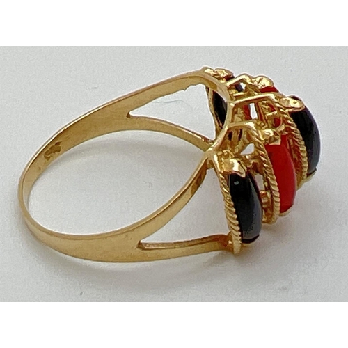 91 - A 14K gold cathedral style dress ring set with marquise cut black onyx and carnelian stones. Gold ma... 