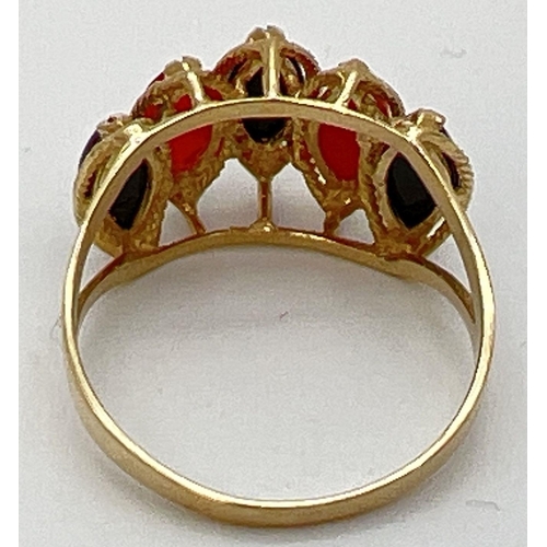 91 - A 14K gold cathedral style dress ring set with marquise cut black onyx and carnelian stones. Gold ma... 