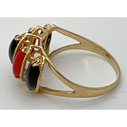 91 - A 14K gold cathedral style dress ring set with marquise cut black onyx and carnelian stones. Gold ma... 