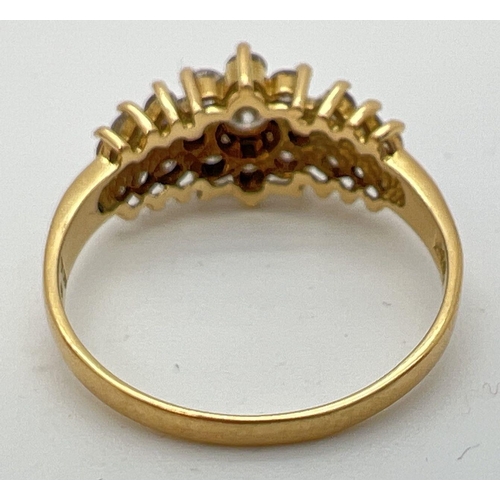 30 - An 18ct gold .70ct diamond cluster style ring. Central round cut diamond surrounded by 8 small round... 