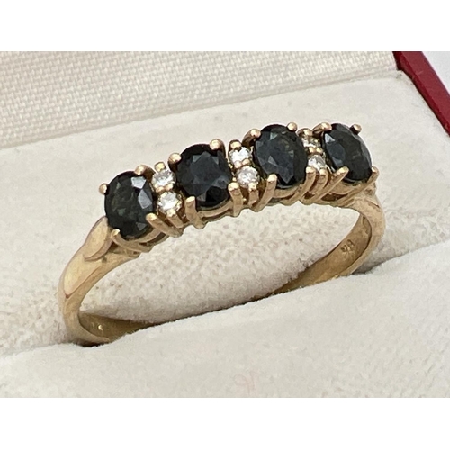 67 - A 9ct gold sapphire and diamond half eternity ring. Set with 4 round cut dark sapphires and 6 small ... 