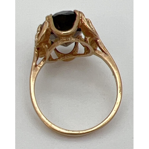 100 - A vintage 9ct gold smoked quartz dress ring set in a fluted style mount. Central oval stone approx. ... 