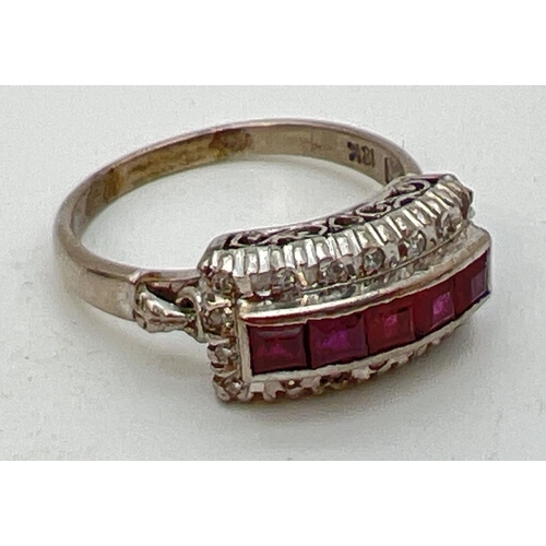 101 - An Art Deco 18ct white gold ruby and diamond dress ring. 5 .16ct square cut rubies in a central high... 