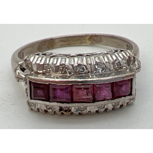 101 - An Art Deco 18ct white gold ruby and diamond dress ring. 5 .16ct square cut rubies in a central high... 