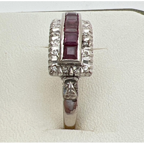 101 - An Art Deco 18ct white gold ruby and diamond dress ring. 5 .16ct square cut rubies in a central high... 