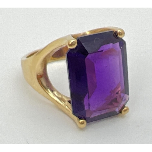 108 - A 14ct gold statement cocktail ring set with a large emerald cut amethyst stone. Gold marks to insid... 