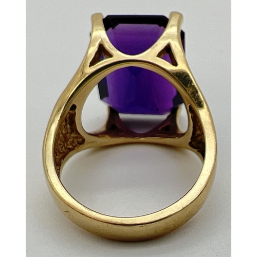 108 - A 14ct gold statement cocktail ring set with a large emerald cut amethyst stone. Gold marks to insid... 