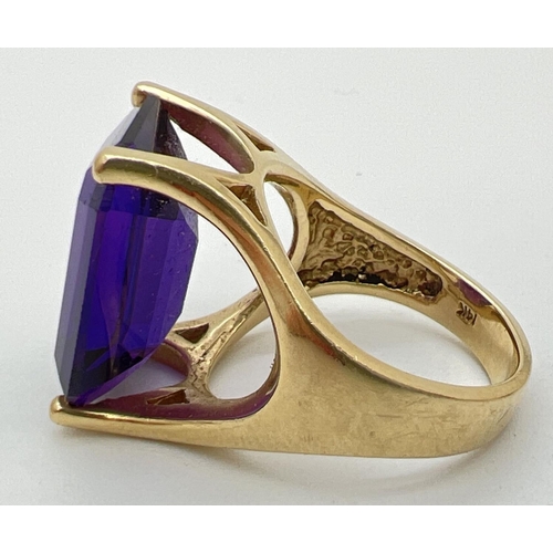 108 - A 14ct gold statement cocktail ring set with a large emerald cut amethyst stone. Gold marks to insid... 