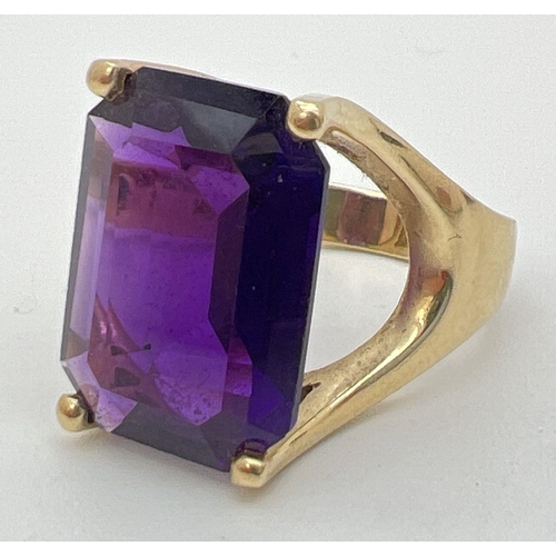 108 - A 14ct gold statement cocktail ring set with a large emerald cut amethyst stone. Gold marks to insid... 