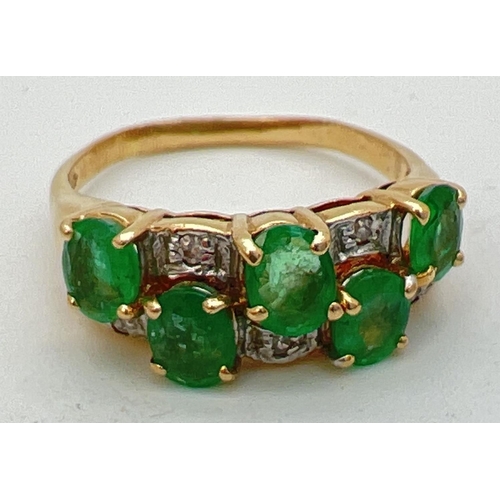 110 - A vintage style 14K gold, emerald and diamond dress ring. Two rows of oval cut emeralds with alterna... 