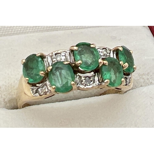 110 - A vintage style 14K gold, emerald and diamond dress ring. Two rows of oval cut emeralds with alterna... 