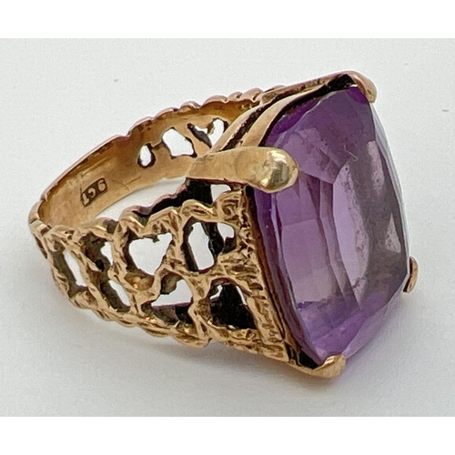 113 - A vintage 9ct gold statement cocktail ring set with a large square cut amethyst in an open work bark... 