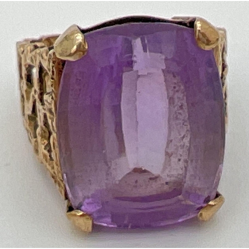 113 - A vintage 9ct gold statement cocktail ring set with a large square cut amethyst in an open work bark... 