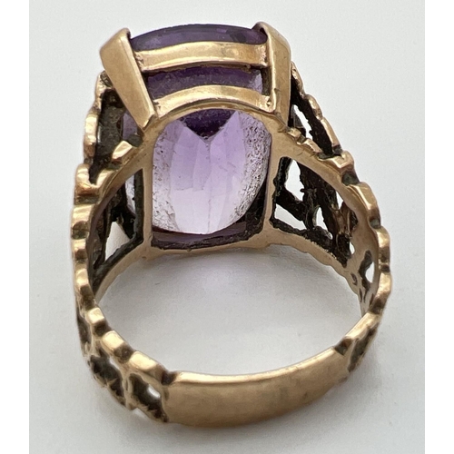 113 - A vintage 9ct gold statement cocktail ring set with a large square cut amethyst in an open work bark... 