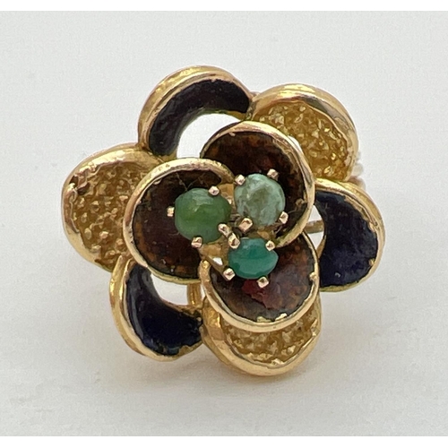 115 - A vintage 18ct gold bespoke made dress ring in the shape of a flower with 3 midnight blue enameled p... 