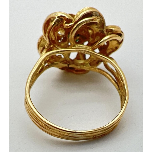 115 - A vintage 18ct gold bespoke made dress ring in the shape of a flower with 3 midnight blue enameled p... 