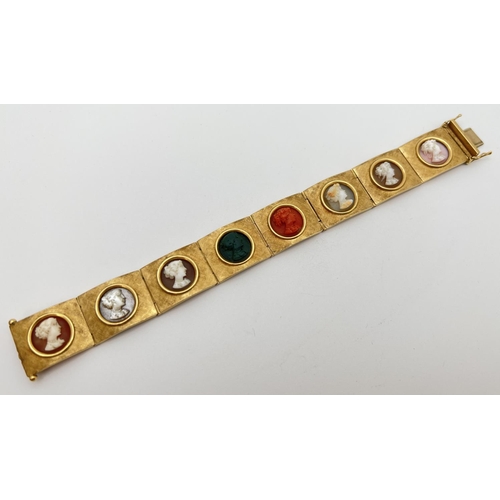 11 - A vintage 8 panel 18ct brushed gold bracelet set with varying colour semi-precious stone cameos. Pus... 