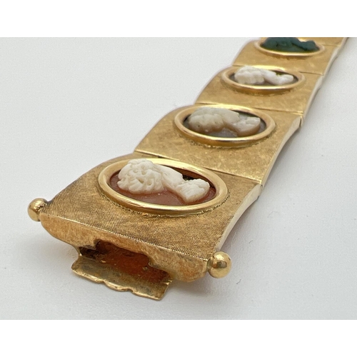 11 - A vintage 8 panel 18ct brushed gold bracelet set with varying colour semi-precious stone cameos. Pus... 