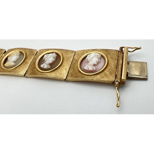 11 - A vintage 8 panel 18ct brushed gold bracelet set with varying colour semi-precious stone cameos. Pus... 