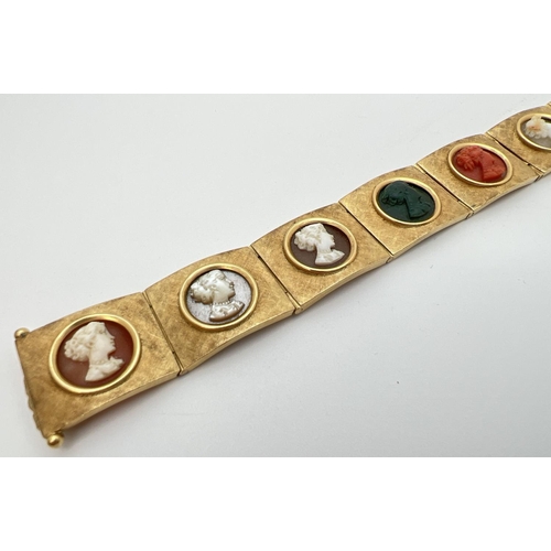 11 - A vintage 8 panel 18ct brushed gold bracelet set with varying colour semi-precious stone cameos. Pus... 