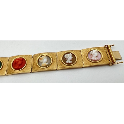 11 - A vintage 8 panel 18ct brushed gold bracelet set with varying colour semi-precious stone cameos. Pus... 