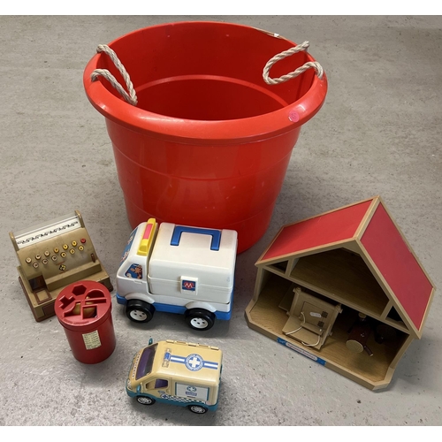 A large red carry tub of assorted vintage plastic toys. To include