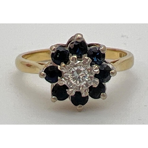 1135 - An 18ct gold diamond and sapphire ring. Central 0.07 ct diamond surrounded by 8 round cut sapphires.... 