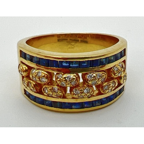 1138 - A gold open work sapphire and diamond band ring. 13 square cut bezel set sapphires to each side with... 