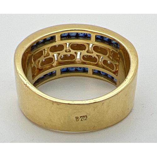 1138 - A gold open work sapphire and diamond band ring. 13 square cut bezel set sapphires to each side with... 