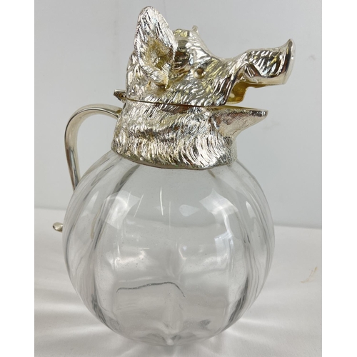 1195 - A large heavy bulbous glass claret jug with silver plated hinged lid in the form of a boars head. Ho... 