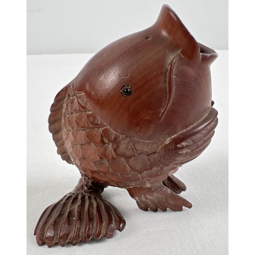 1258 - A small Japanese carved fruitwood pot in the form of an open mouthed fish. Set with small mother of ... 