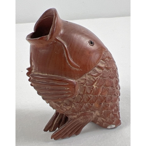 1258 - A small Japanese carved fruitwood pot in the form of an open mouthed fish. Set with small mother of ... 