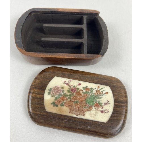 1259 - A small Japanese fruitwood wooden box, sliding lid has carved bone insert with floral decoration. In... 