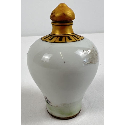 1260 - A small Chinese ceramic snuff bottle with painted erotic scene. Gilt painted stopper and top rim. Ha... 