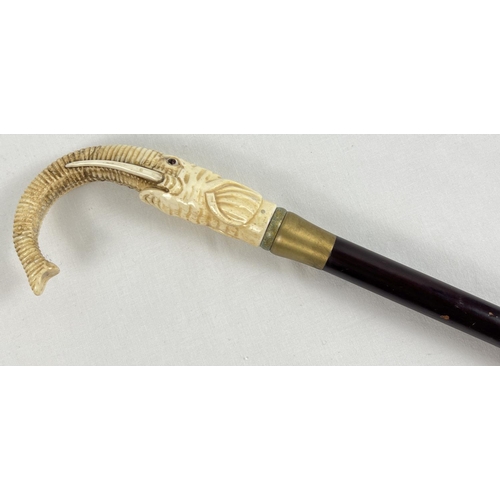 1306 - A bone topped walking cane with screw in finial in the form of an elephant head with curved trunk ha... 