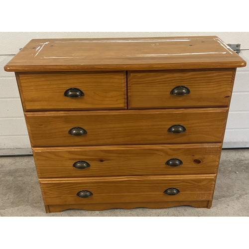 1393 - A modern pine effect 2 over 3 chest of drawers with metal cup handles. Some paint to top of chest an... 