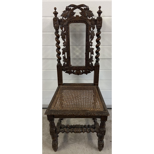 1395 - An antique dark wood hall chair with barley twist columns and carved vine leaf detail. With loose wo... 