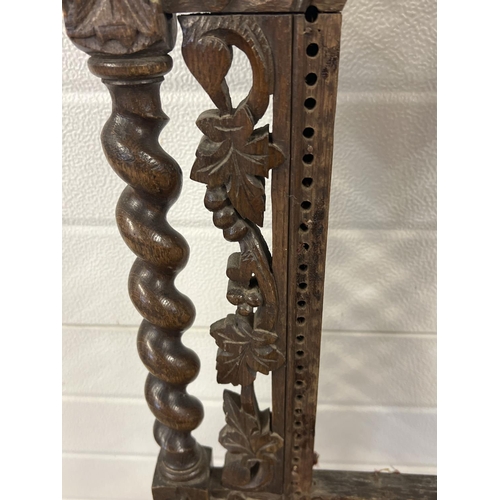 1395 - An antique dark wood hall chair with barley twist columns and carved vine leaf detail. With loose wo... 