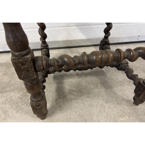 1395 - An antique dark wood hall chair with barley twist columns and carved vine leaf detail. With loose wo... 