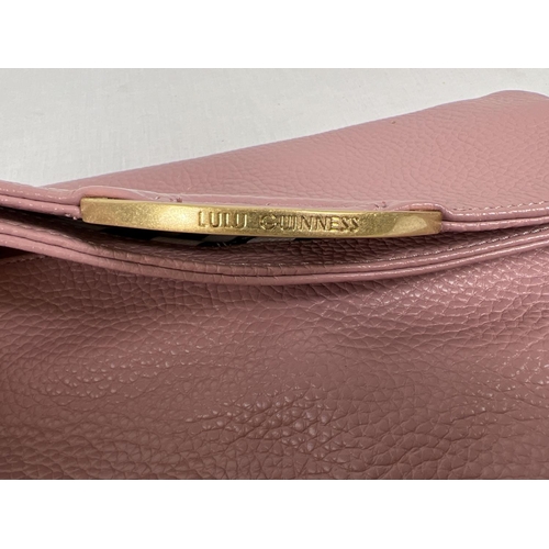 1338 - A pale pink leather clutch bag by Lulu Guinness with lips motif and gold hardware. External back poc... 