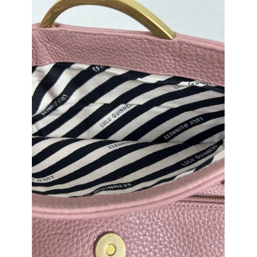 1338 - A pale pink leather clutch bag by Lulu Guinness with lips motif and gold hardware. External back poc... 