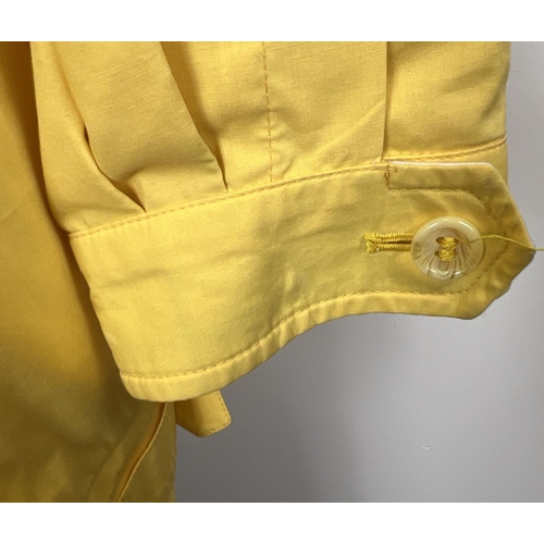 1330 - A ladies Burberrys yellow lightweight jacket. Front zip fastening with button cuffs and side adjusti... 