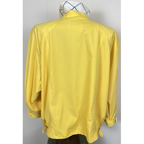 1330 - A ladies Burberrys yellow lightweight jacket. Front zip fastening with button cuffs and side adjusti... 