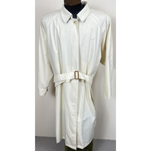 1331 - A cream light weight belted trench coat by Burberrys. Front button fastening with 2 front pockets. B... 