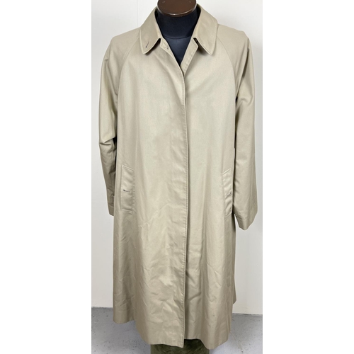 1332 - A beige belted long trench coat by Burberrys. Classic check full length lining, button front fasteni... 