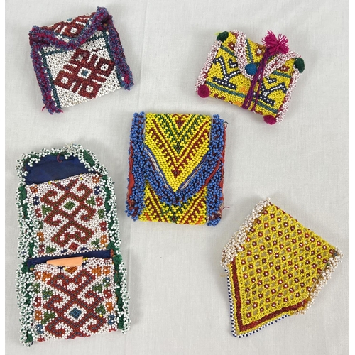 1322 - 5 Central Asian heavily beaded wrap pouches, in varying colours, sizes and designs.