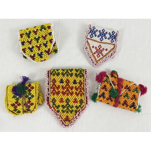 1323 - 5 Central Asian heavily beaded wrap pouches, in varying colours, sizes and designs.